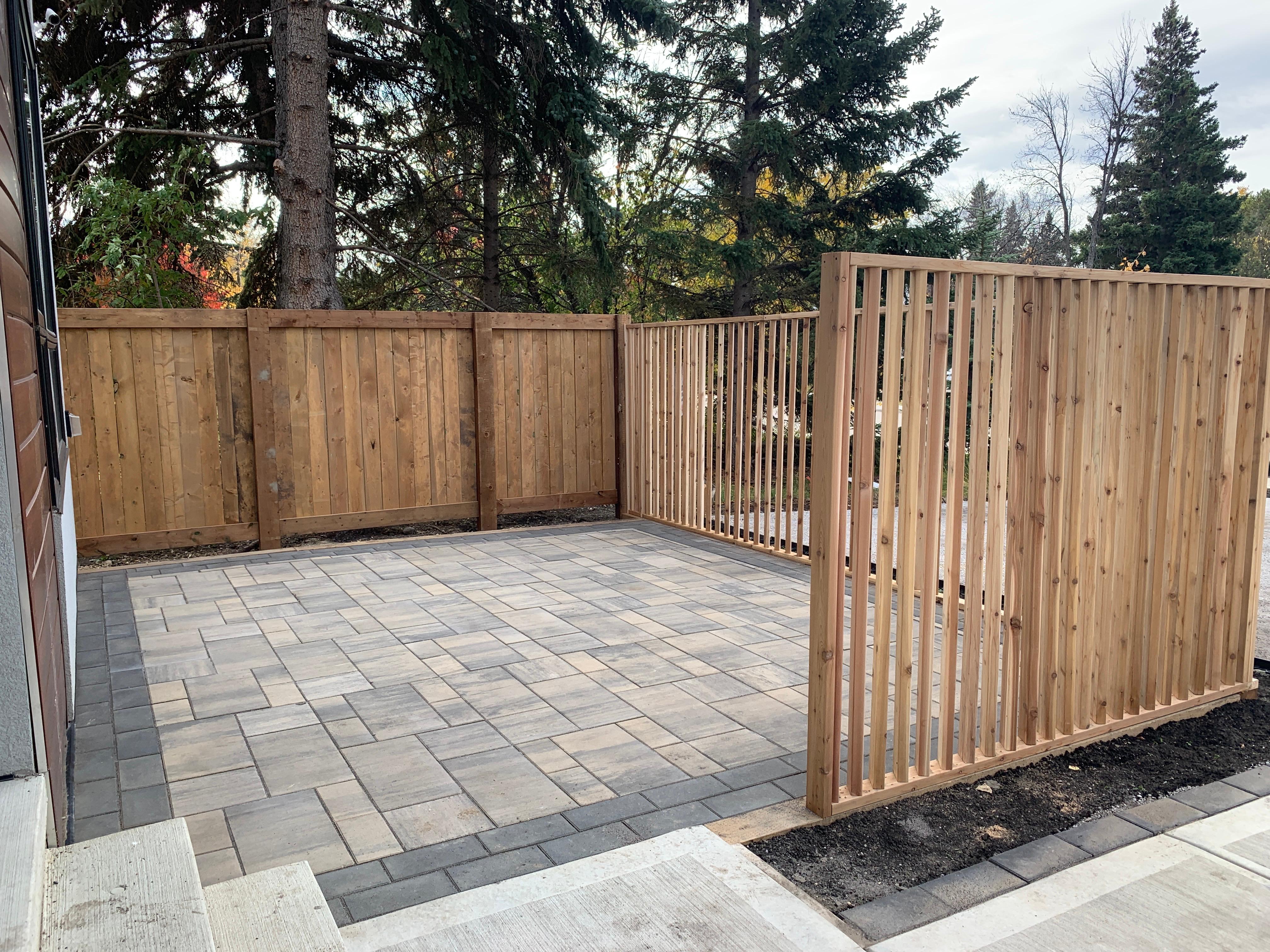 Backyard paver patio with new cedar fence and privacy screen